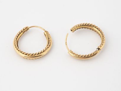Pair of creoles in yellow gold (750) decorated...
