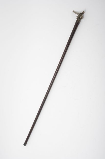 null Wooden cane with its silver-plated bronze knob featuring a man with a pointed...