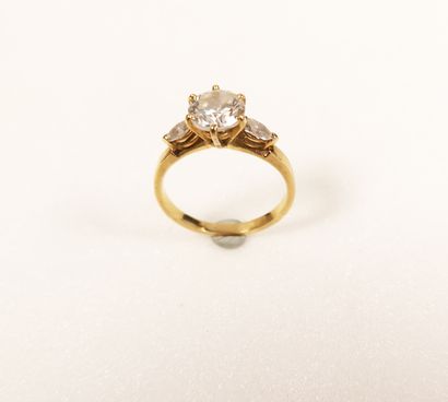 null Yellow gold (750) ring centered with a half-size diamond in claw setting and...