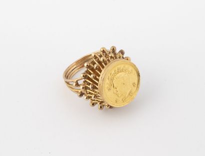 null Yellow gold (750) ring set with an Iranian coin in closed setting on a raised...