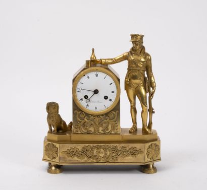 null Small clock in brass and chased bronze, gilded, flanked by a gamekeeper accompanied...