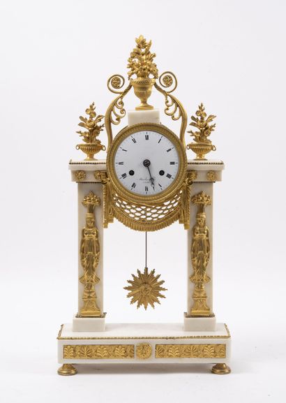 null Portico clock in white marble and gilt bronze.

Decorated with Egyptian canephoras...