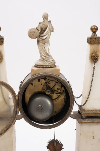 null Portico clock in white marble. 

Formed by two obelisks supporting the round...