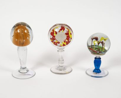 null Three wig holders with spherical, flattened or ovoid heads, in colorless glass...