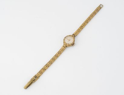 Kiplé Petite montre de dame en acier inoxydable et métal doré.

Cadran à fond ivoire,...