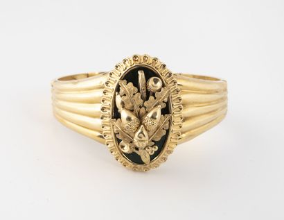null Bracelet rigide godronné articulé en or jaune (750) centré d'un médaillon ovale...