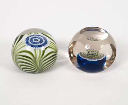 MURANO Two paperweight balls in colorless glass with inclusions of candies in millefiori...