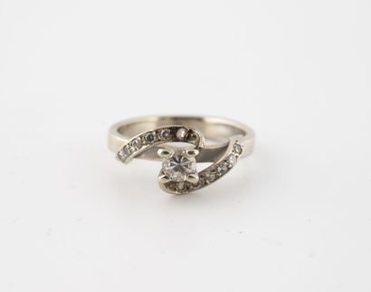 null White gold ring (750) centered on a brilliant-cut diamond in a claw setting,...