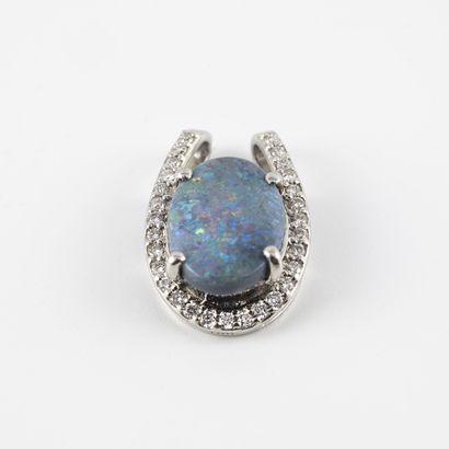 null Platinum (850) pendant centered on a cabochon of blue opal in a claw setting...