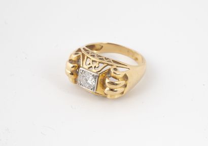 null A yellow gold (750) ring with a gadrooned shoulder and openwork setting, centered...