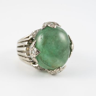 null White gold ring (750) centered on a large emerald cabochon held by claws in...
