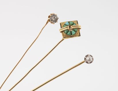 null Lot of three yellow gold (750) pins, one set with an old-cut diamond, the other...