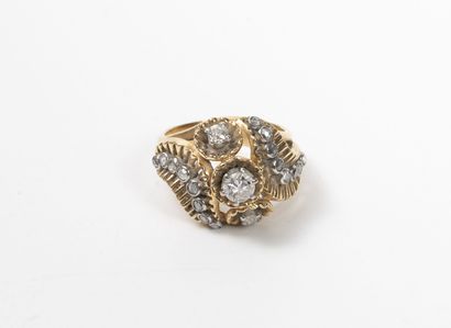 null Yellow and white gold (750) ring with openwork bezel set with three brilliant-cut...