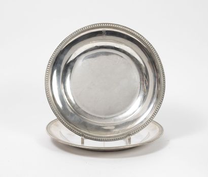 null Two round silver dishes (950) with edges underlined by nets of a frieze of water...