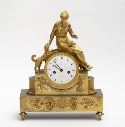 null Gilt bronze and brass clock with a seated woman caressing a dog, symbolizing...