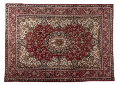 IRAN Rectangular wool carpet polychrome formed by a large cartouche with red fields...