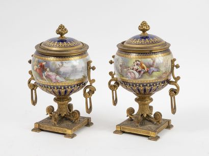 null Pair of covered round-bodied vases, in polychrome enamelled porcelain and gilt...