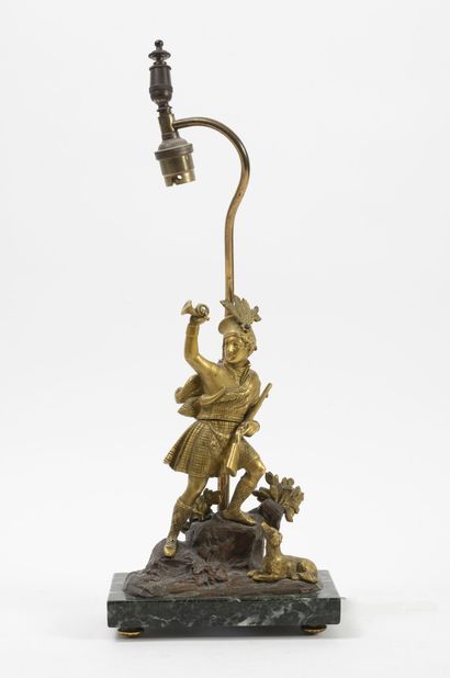 null A Scottish hunter and his dog in gilt and patinated bronze, adorning a lamp...