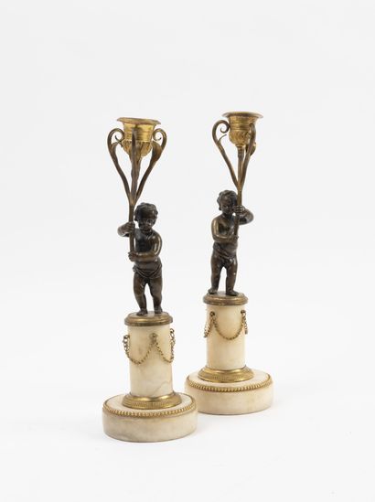 Pair of bronze and brass torches, patinated...