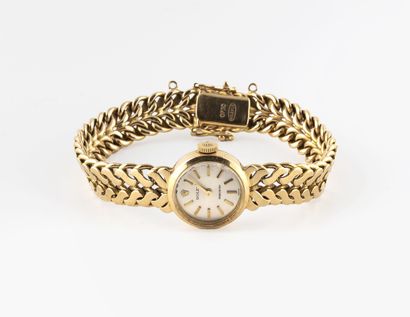 ROLEX Ladies' wristwatch in yellow gold (750).
Round case. 
Dial with silvered background,...