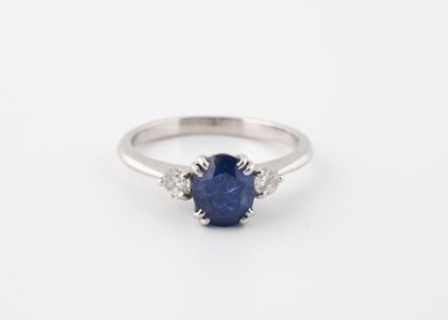 null White gold ring (750) centered on a sapphire probably synthetic set with two...