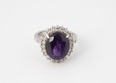 null Platinum ring (850) centered on an oval faceted amethyst in a claw setting,...