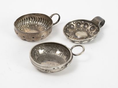 null Three tastevins :
- one in silver (800) decorated with radiating gadroons, flowers...
