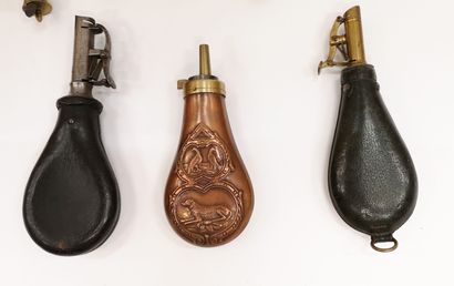 null Eight powder or lead flasks in blackened leather, stamped copper with a hunting...