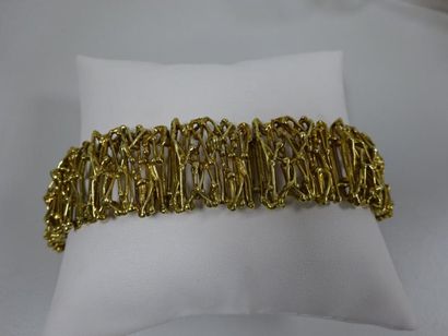 null Bracelet articulé en or jaune ajouré (750) formé de huit motifs de treillage....