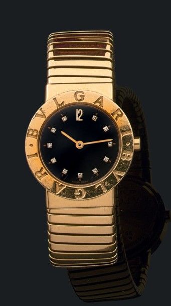 BULGARI 
"BULGARI"
Montre bracelet de dame en or (750).
Cadran noir avec index diamantés.
Lunette...