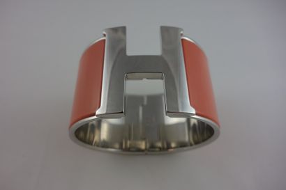 HERMES Bracelet manchette "Clic H" grand modèle en métal palladié et émail rose corail.

Avec...