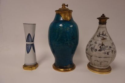 null Trois vases :

- un en forme de diabolo en porcelaine blanche à deux frises...