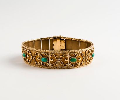 null Bracelet ruban articulé en or jaune (750) à décor de motifs en accolades, ponctué...