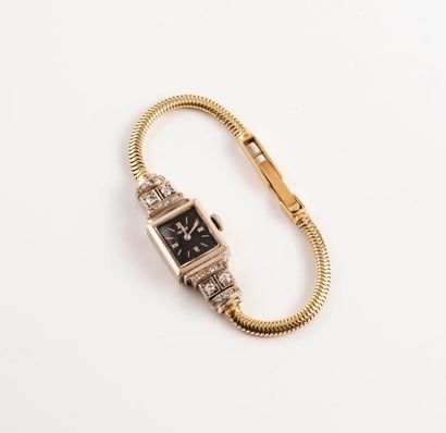 HERWALT 

Montre bracelet de dame en ors jaune et gris (585) 

Boîtier carré, attaches...