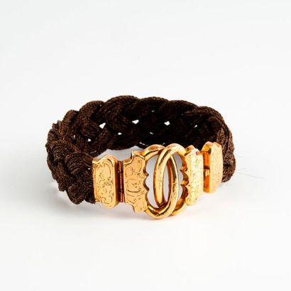 null Bracelet de cheveux tressés, fermoir en or jaune (750) à motifs de deux anneaux...