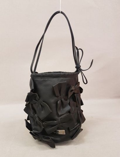 VALENTINO 

Petit sac seau porté main en cuir lisse noir décoré de noeuds. 

16 x...