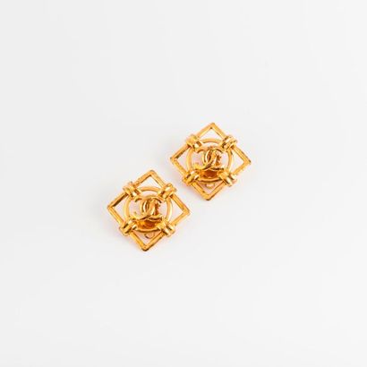 CHANEL 
Paire de clips d'oreille en métal doré de forme carrée, ajourée et centrée...