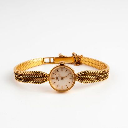 MOVADO 
Montre bracelet de dame en or jaune (750). 
Boîtier rond. 
Cadran fond crème,...