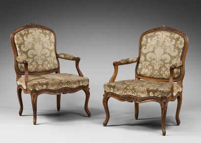 null Pair of flat-back beechwood armchairs carved with asymmetrical cartouches, flowers...