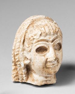 null Head of a female deity from a statuette, the hollowed out eyes and eyebrows...