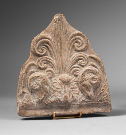 null *Antefix decorated with a palmette flanked by two ram heads.
Terracotta.
Roman...