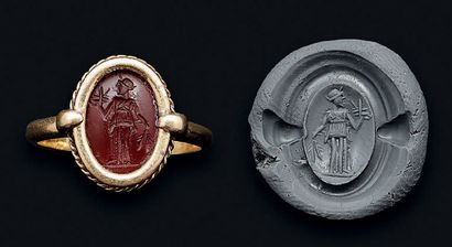 null Intaglio engraved with a divinity. Red carnelian.
Roman art, 2nd century. Modern...