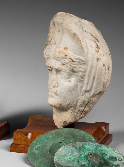 null Fragmentary female head from a statue or bust. The wavy hair on either side...