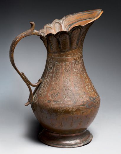 null Candlestick and large ewer in copper, engraved with floral and epigraphic motifs....