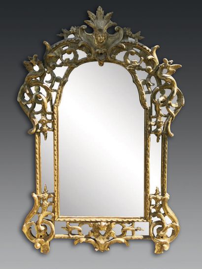 null A carved and gilded wood REGENCY MIRROR, the angles with scrolls and "pigtail",...