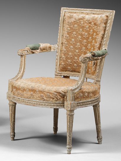 null A cream-coloured repainted wood armchair with a flared back, carved with twisted...