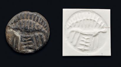 null Large, double-sloped discoidal seal engraved with a large deer adorned with...