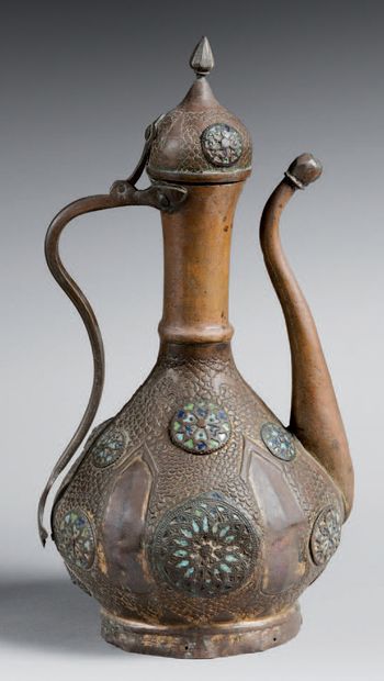 null A copper ewer with a globular body and a lid surmounted by a lanceolate grip,...