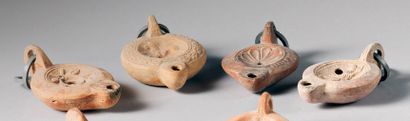 null Set of four oil lamps decorated with a rosette, a donkey, a figure (signed)...
