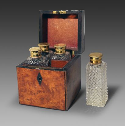null PARFUM CASE in burr wood and blackened wood veneer, containing four cut crystal...